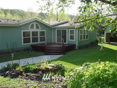 982 Bunker Creek Road Chehalis, WA 98532 - Photo 1 of 1 a front view of a house with a yard table and chairs