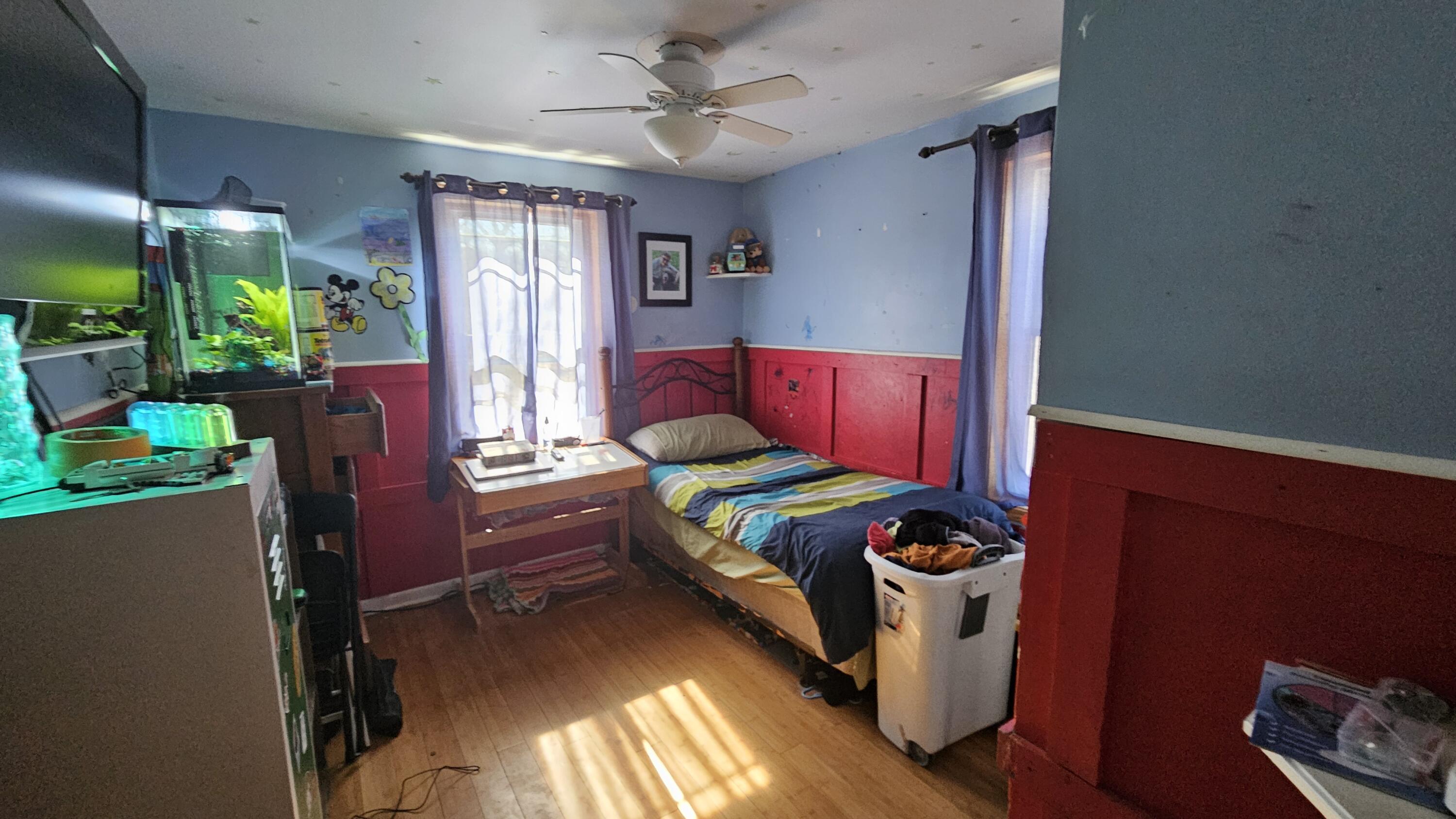 2700 Blake Road Portage, IN 46368 - Photo 6 of 8 a bedroom with furniture and a potted plant