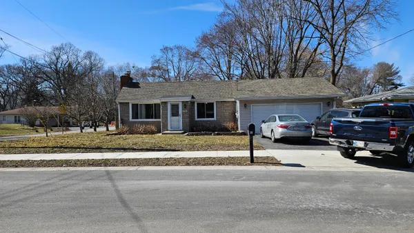 a view of a parked cars in front of house