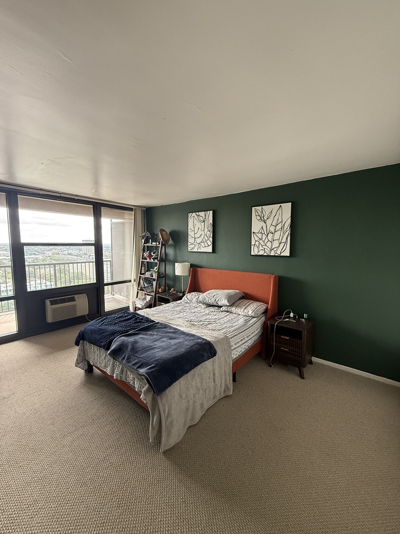 3001 South Michigan Avenue, Unit 2104 Chicago, IL 60616 - Photo 8 of 15 a spacious bedroom with a bed chairs and a window