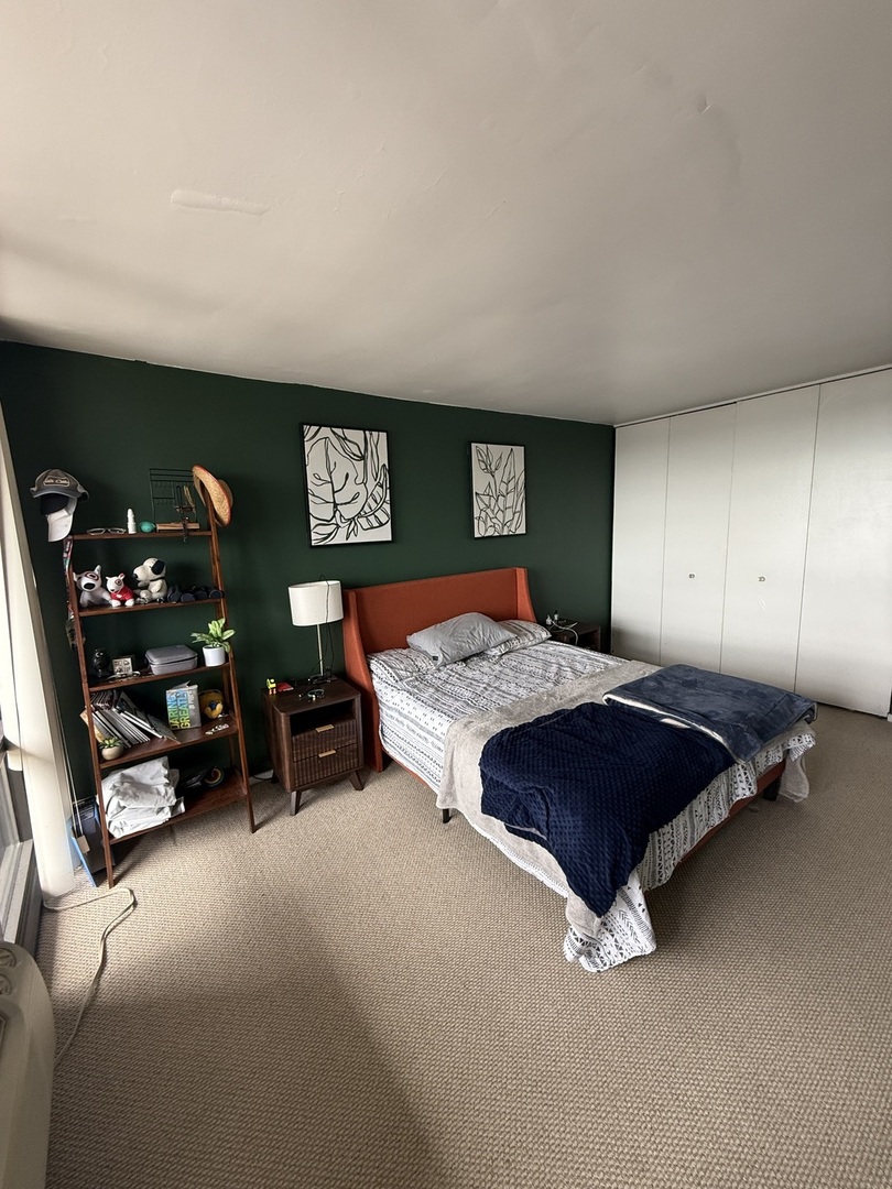 3001 South Michigan Avenue, Unit 2104 Chicago, IL 60616 - Photo 9 of 15 a bedroom with a bed and a chair