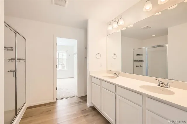 a bathroom with a sink double vanity and a mirror