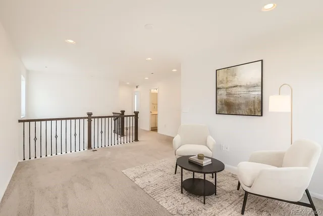 a living room with furniture and a black wall painting