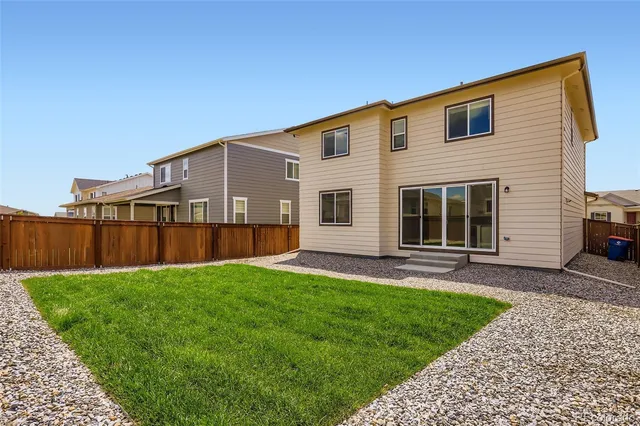 a view of a house with a yard and pathway