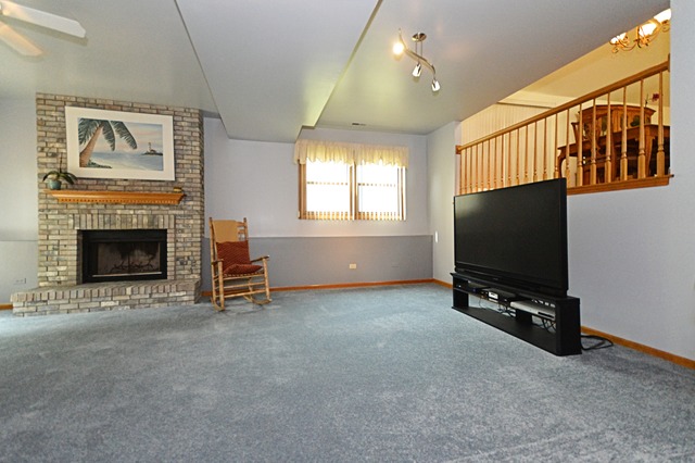 1710 Chestnut Hill Road Plainfield, IL 60586 - Photo 11 of 25 a living room with furniture and a flat screen tv