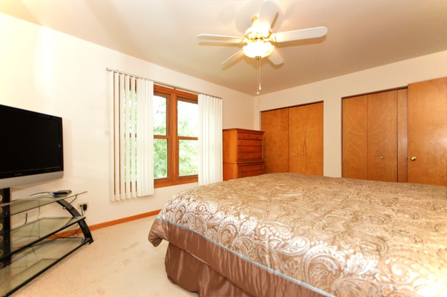 1710 Chestnut Hill Road Plainfield, IL 60586 - Photo 17 of 25 a bedroom with a bed and a flat screen tv