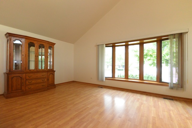 1710 Chestnut Hill Road Plainfield, IL 60586 - Photo 3 of 25 a view of an empty room with wooden floor and a window
