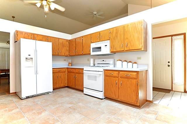 1710 Chestnut Hill Road Plainfield, IL 60586 - Photo 8 of 25 a kitchen with stainless steel appliances granite countertop a stove a sink and a refrigerator