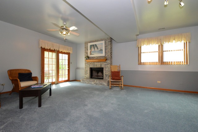 1710 Chestnut Hill Road Plainfield, IL 60586 - Photo 9 of 25 a living room with furniture and a fireplace
