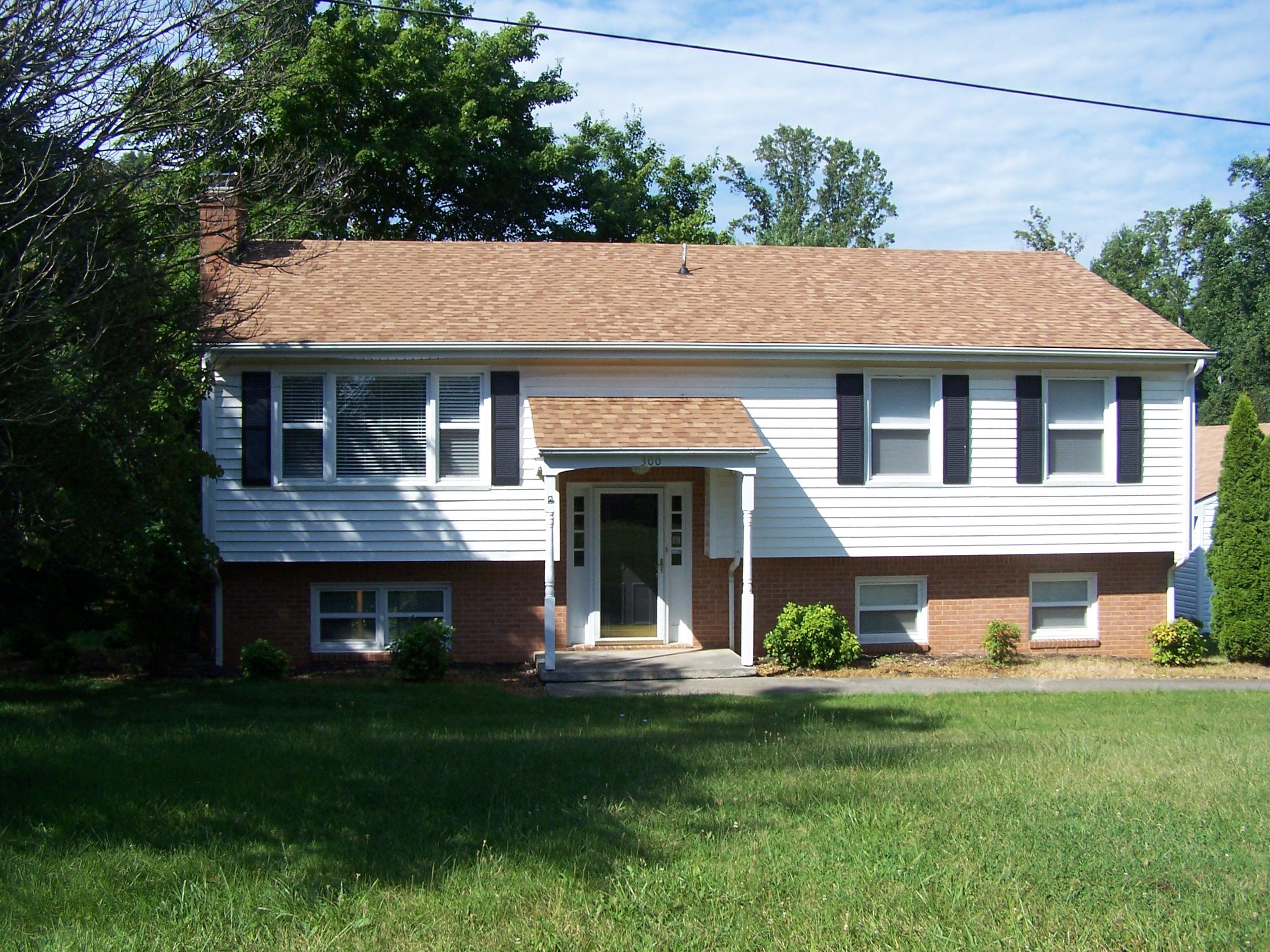300 Ridge Drive Goodview, VA 24095 - Photo 1 of 19 a backyard of a house with potted plants and large tree