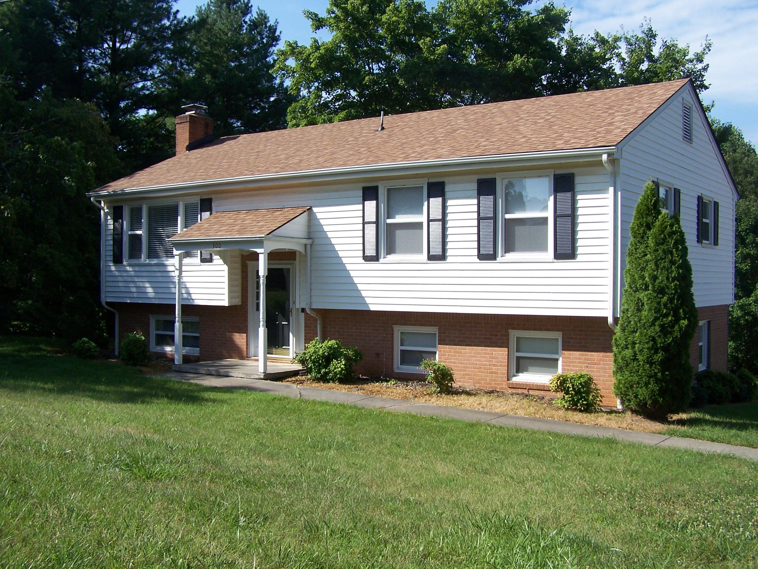 300 Ridge Drive Goodview, VA 24095 - Photo 2 of 19 a front view of a house with a yard and garage