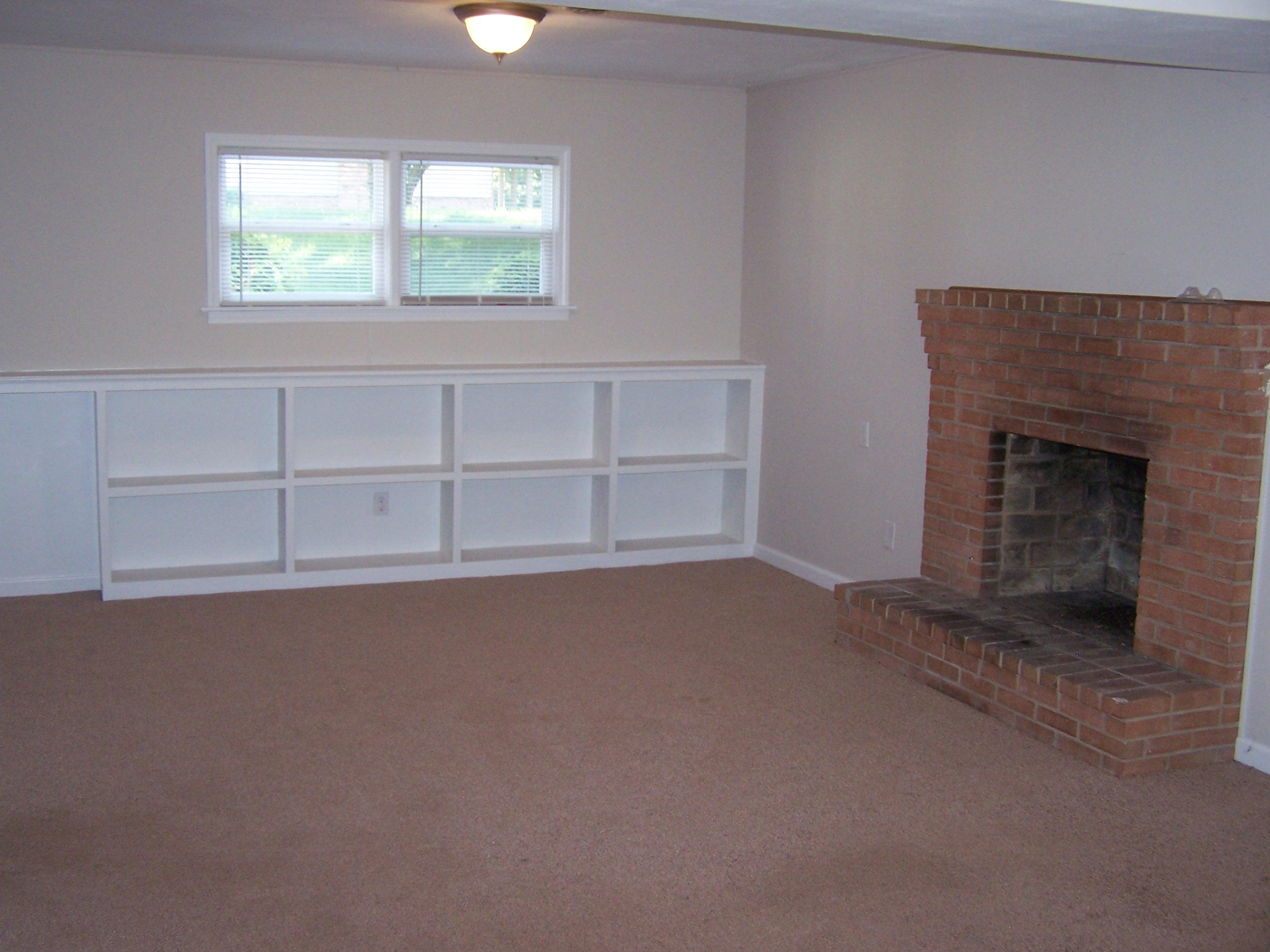 300 Ridge Drive Goodview, VA 24095 - Photo 19 of 19 an empty room with a fireplace and window