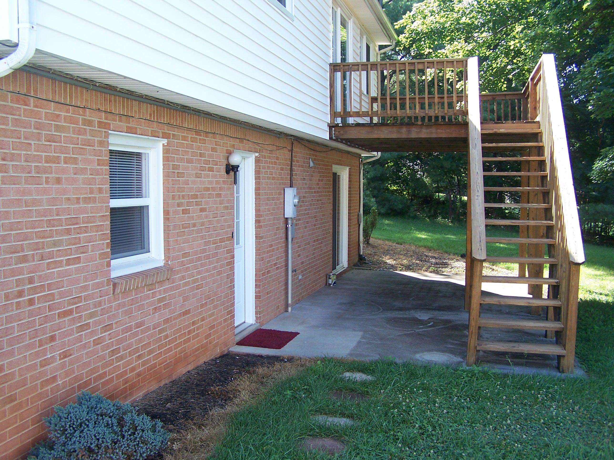 300 Ridge Drive Goodview, VA 24095 - Photo 4 of 19 a view of a backyard with plants and large trees