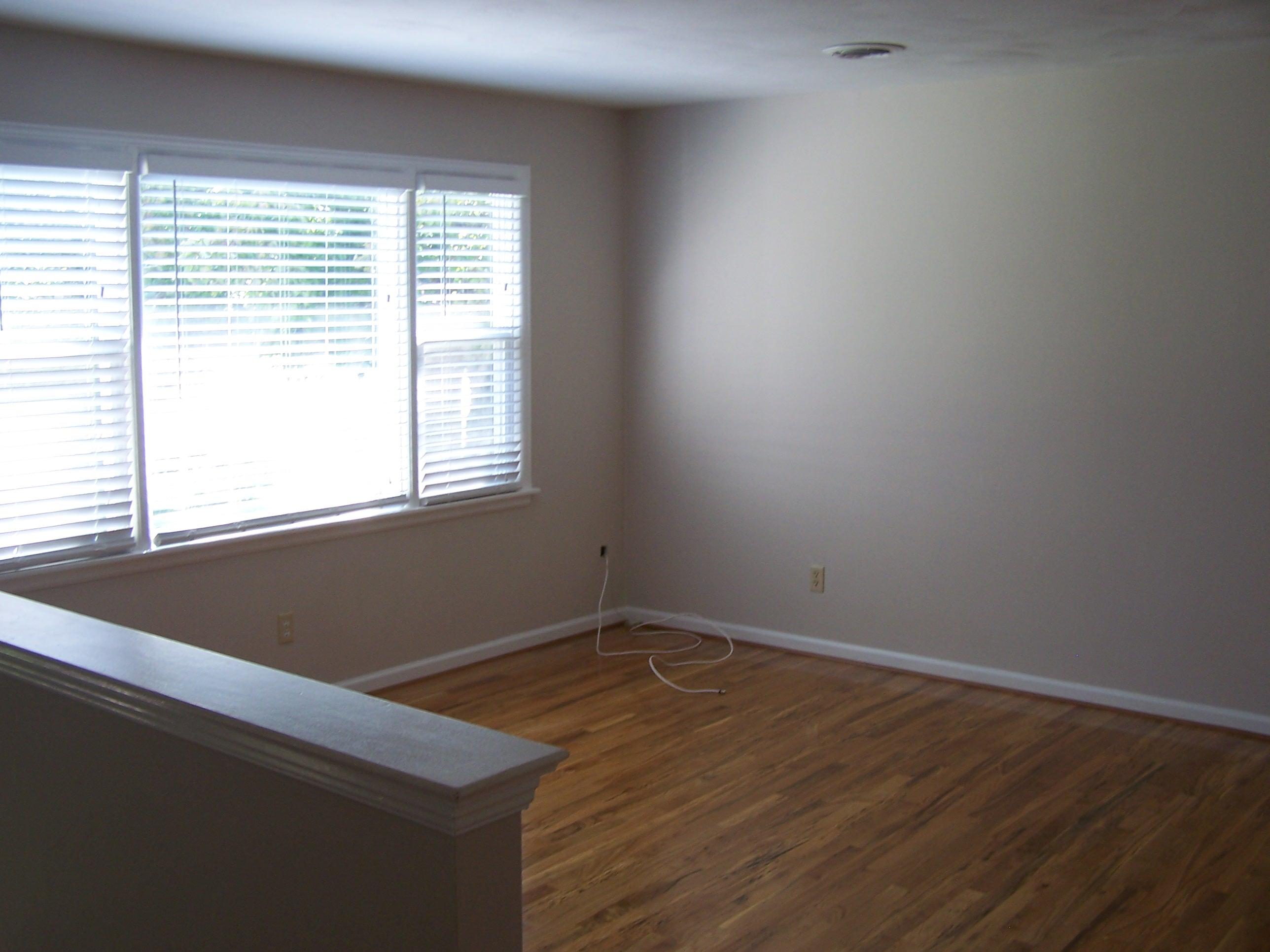 300 Ridge Drive Goodview, VA 24095 - Photo 9 of 19 an empty room with wooden floor and a window