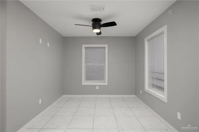 a view of an empty room with a window