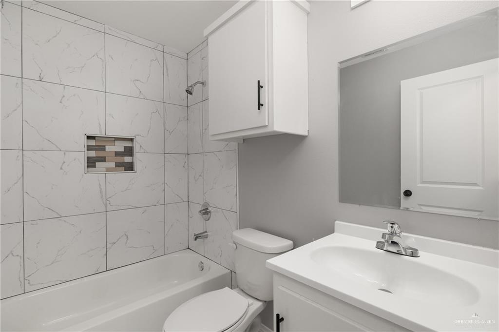 1426 East Rogers Road, Unit 52 Edinburg, TX 78542 - Photo 7 of 13 a bathroom with a sink toilet and shower