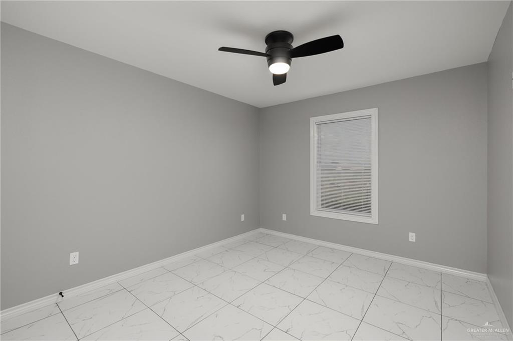 1426 East Rogers Road, Unit 52 Edinburg, TX 78542 - Photo 8 of 13 an empty room with ceiling fan and window