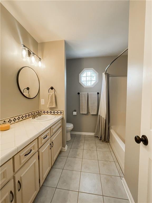 280 Mimosa Road Phenix City, AL 36870 - Photo 26 of 38 Full bath featuring vanity, light tile patterned flooring, and shower / bath combination with curtain