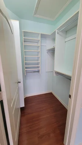 a view of a room with wooden floors and stairs