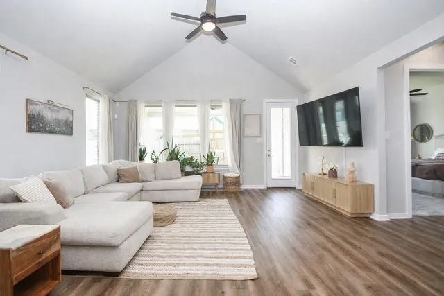 a living room with furniture and view of kitchen