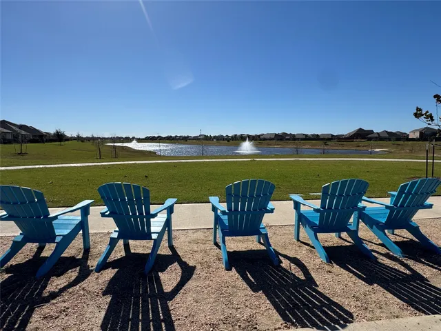 a view of a lake with furniture