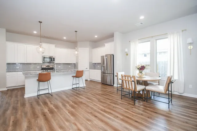 a large kitchen with stainless steel appliances granite countertop a stove and a sink