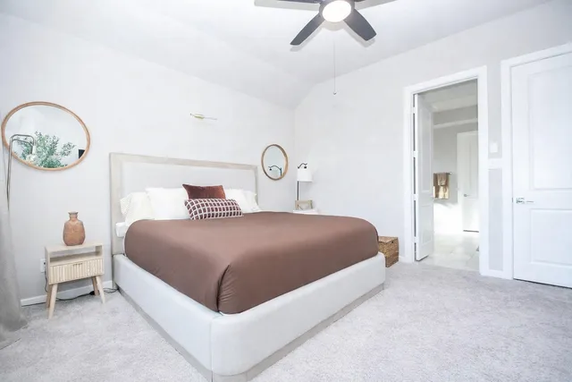 a bedroom with a large bed and a window