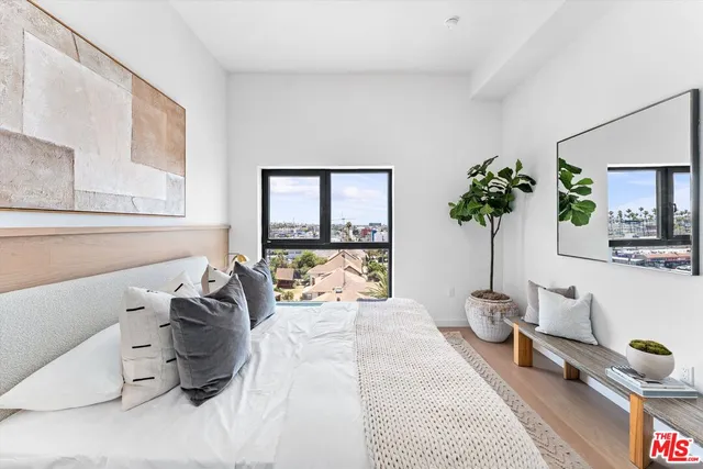 a bedroom with furniture and a potted plant
