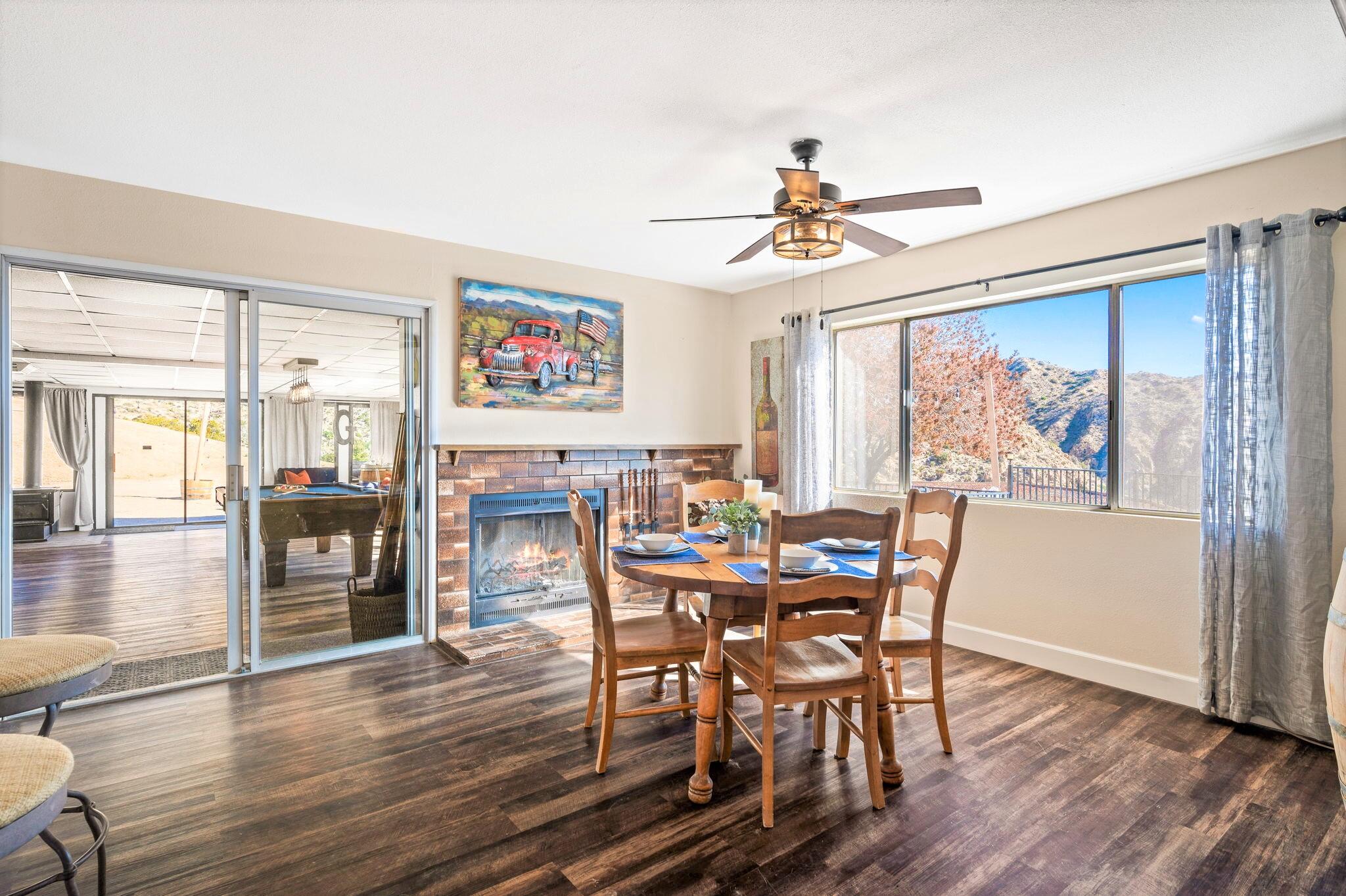 53988 Pinon Drive Yucca Valley, CA 92284 - Photo 17 of 42 a view of a dining room with furniture window and wooden floor