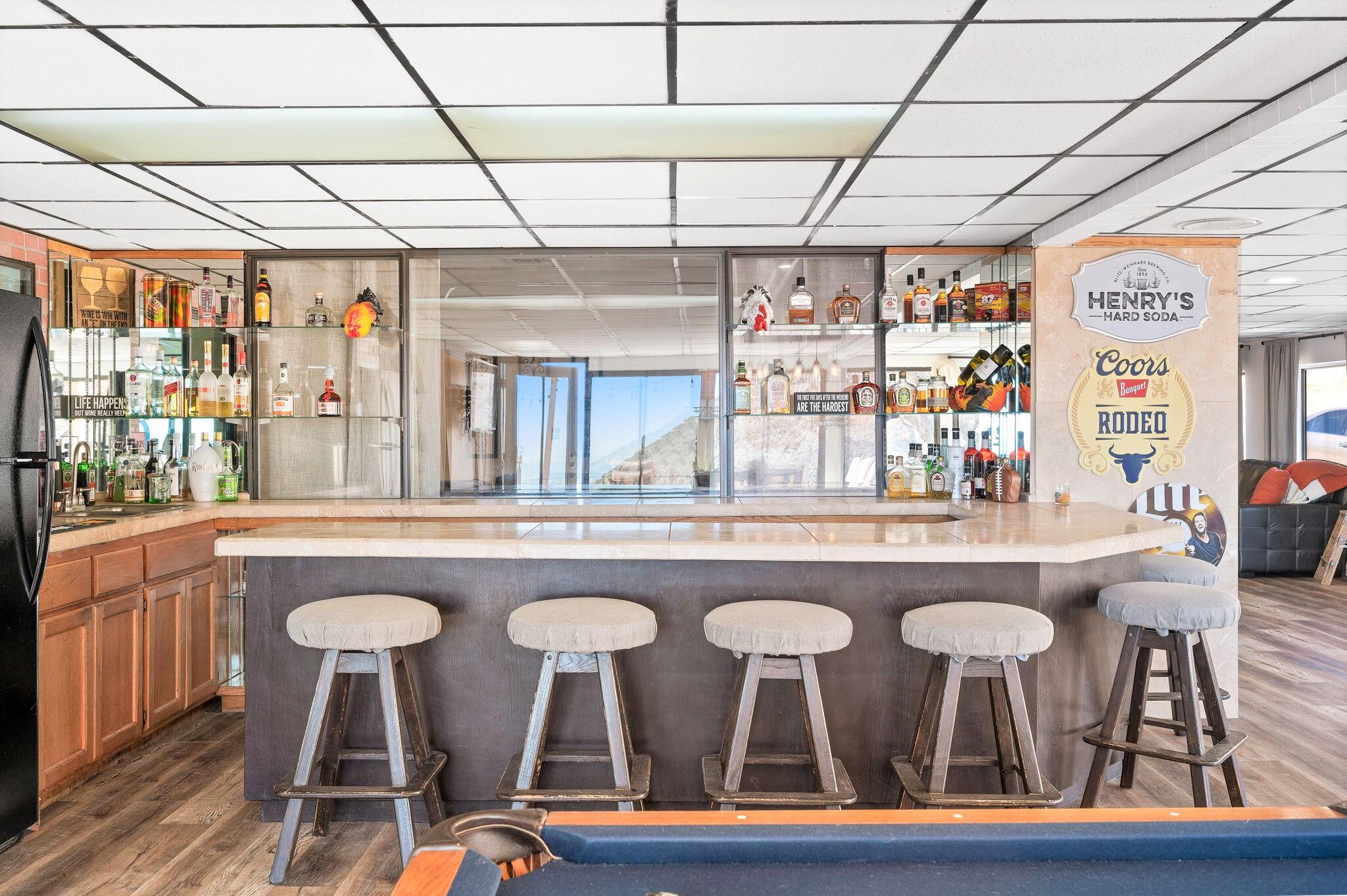 53988 Pinon Drive Yucca Valley, CA 92284 - Photo 22 of 42 a kitchen with a table chairs wooden floors and a view of living room