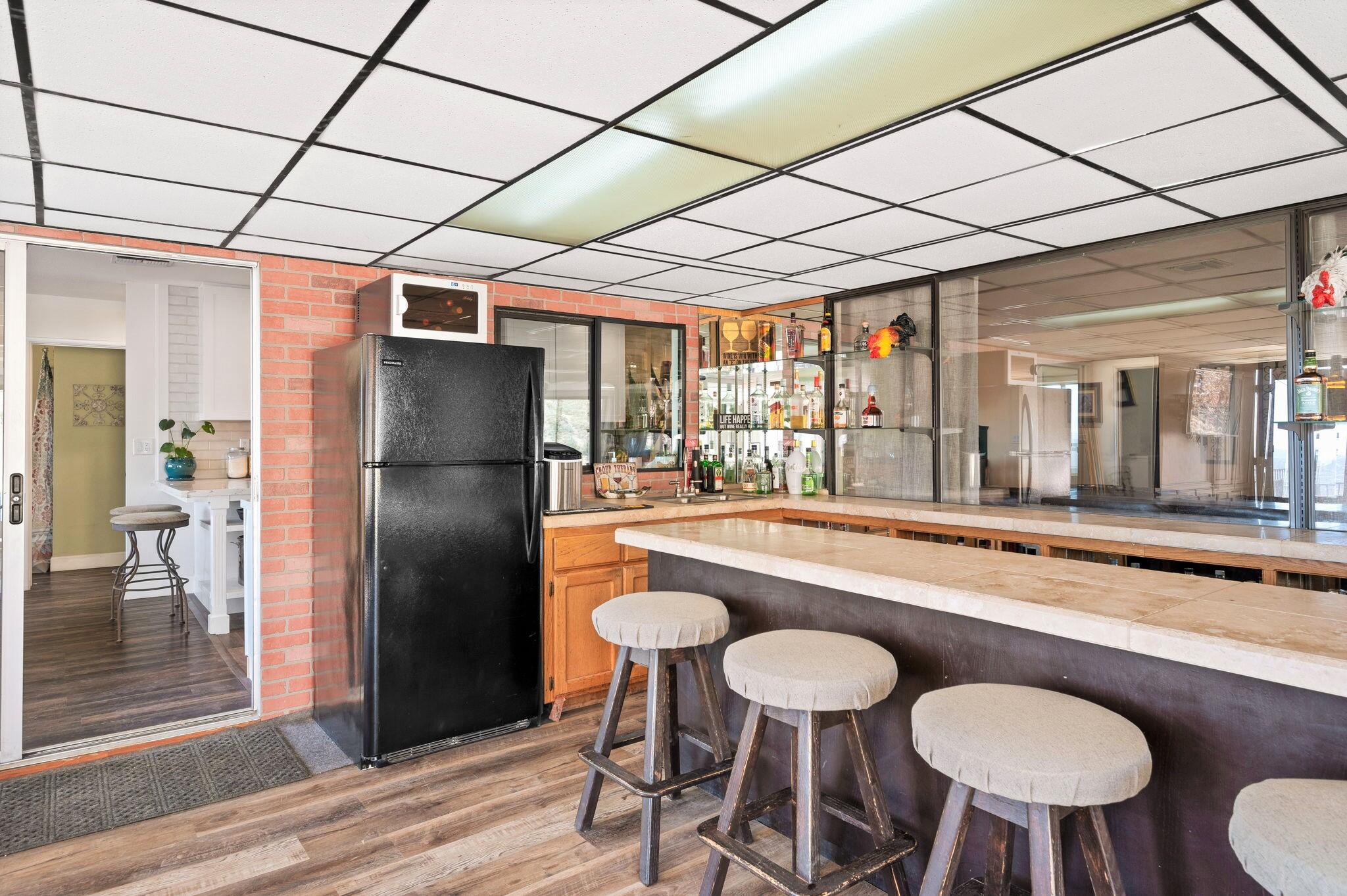 53988 Pinon Drive Yucca Valley, CA 92284 - Photo 23 of 42 a kitchen with stainless steel appliances granite countertop a table chairs and a refrigerator