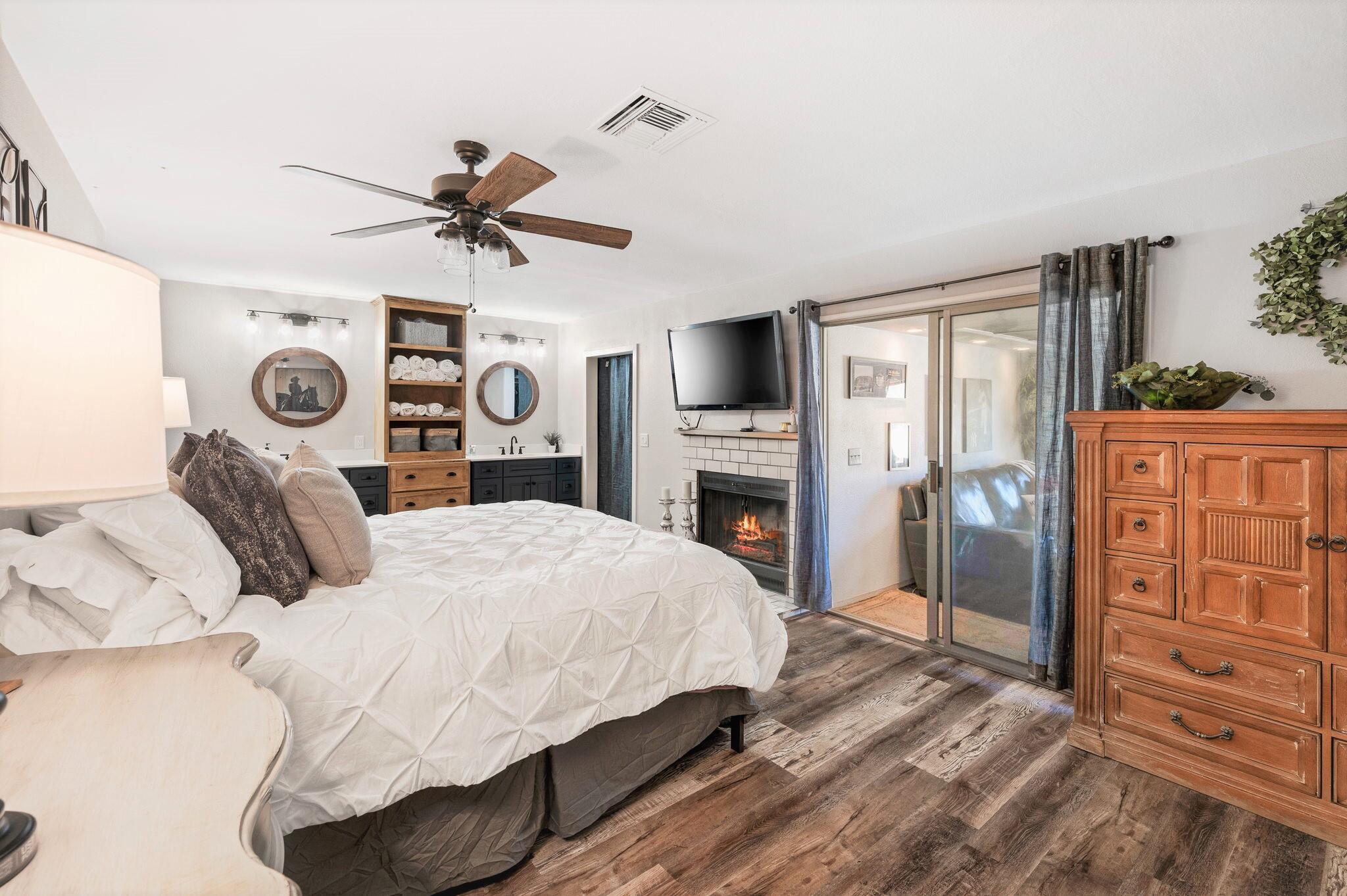 53988 Pinon Drive Yucca Valley, CA 92284 - Photo 27 of 42 a bedroom with a bed a dresser and flat screen tv