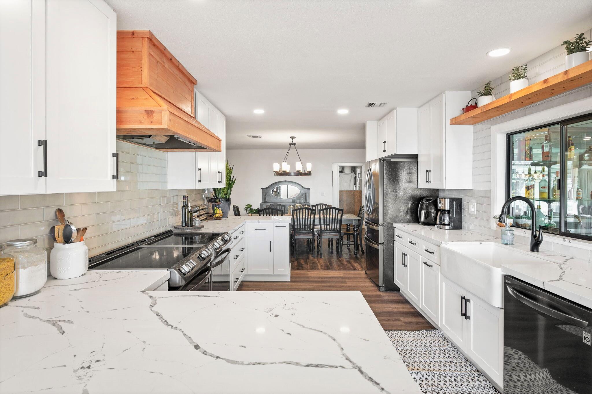 53988 Pinon Drive Yucca Valley, CA 92284 - Photo 8 of 42 a kitchen with stainless steel appliances kitchen island granite countertop a sink and cabinets