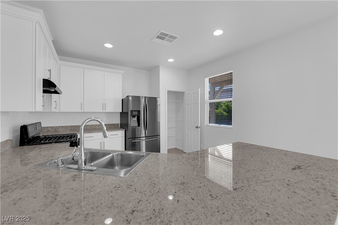 9205 Keystone Ridge Avenue Las Vegas, NV 89148 - Photo 12 of 40 Kitchen featuring stainless steel fridge, gas rang