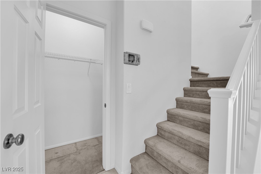 9205 Keystone Ridge Avenue Las Vegas, NV 89148 - Photo 18 of 40 Staircase with carpet flooring and baseboards