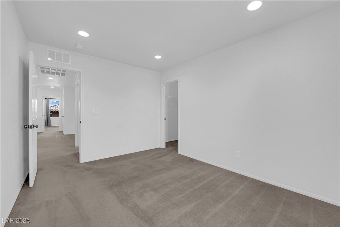 9205 Keystone Ridge Avenue Las Vegas, NV 89148 - Photo 24 of 40 Carpeted empty room with recessed lighting and bas
