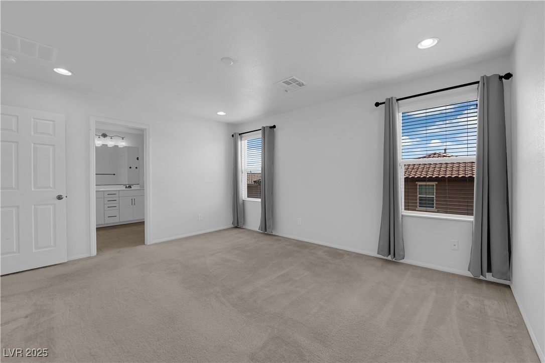 9205 Keystone Ridge Avenue Las Vegas, NV 89148 - Photo 30 of 40 Unfurnished bedroom with light carpet, recessed li