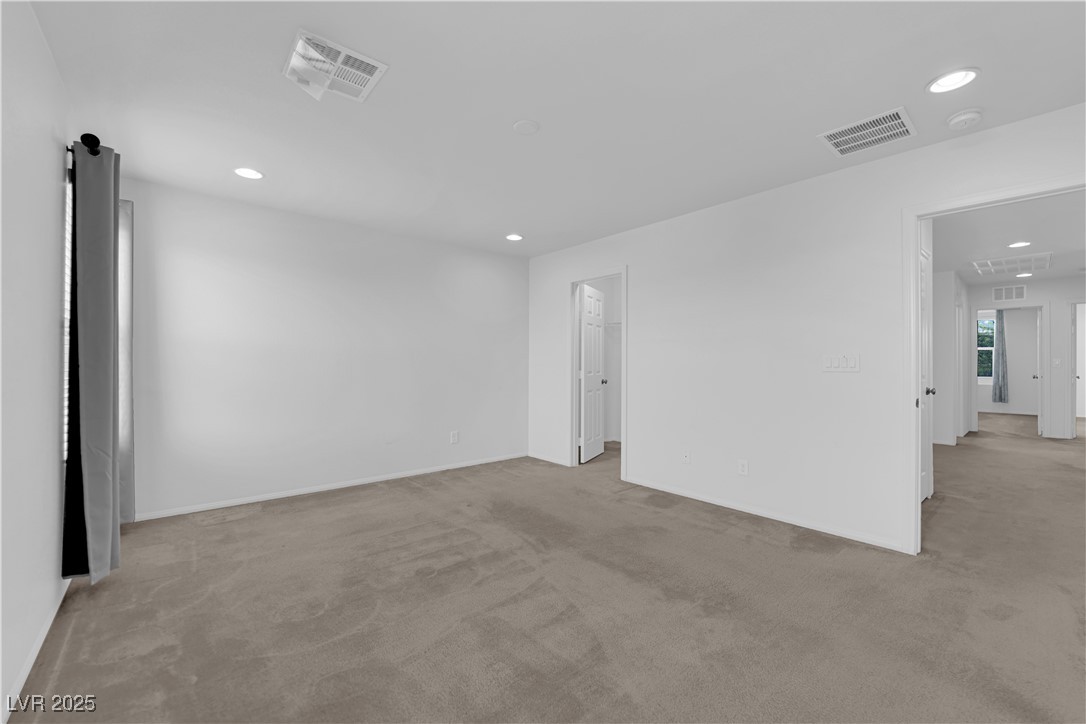 9205 Keystone Ridge Avenue Las Vegas, NV 89148 - Photo 31 of 40 Empty room with light colored carpet and recessed