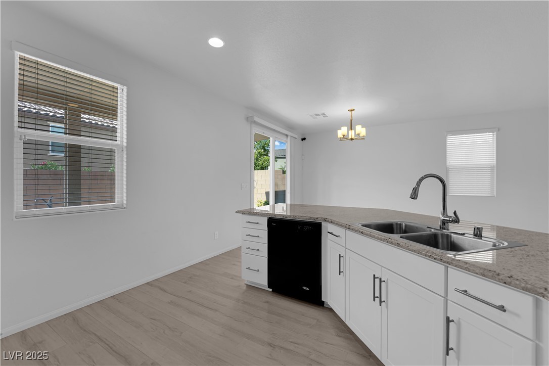 9205 Keystone Ridge Avenue Las Vegas, NV 89148 - Photo 10 of 40 Kitchen with a chandelier, black dishwasher, white