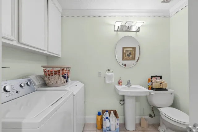 a bathroom with a toilet a sink and a mirror