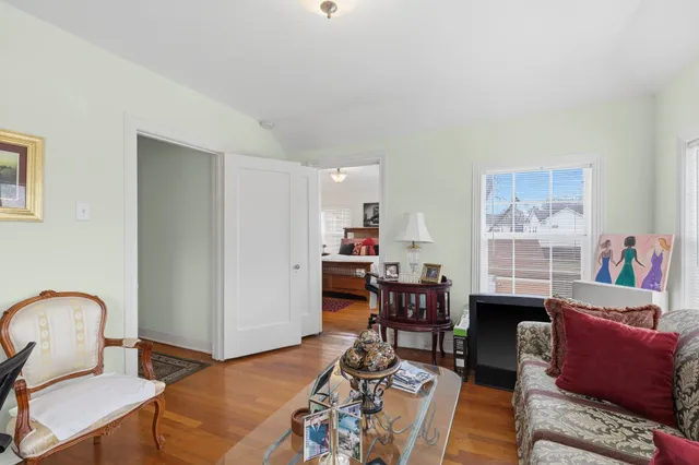 a living room with furniture a rug and a window