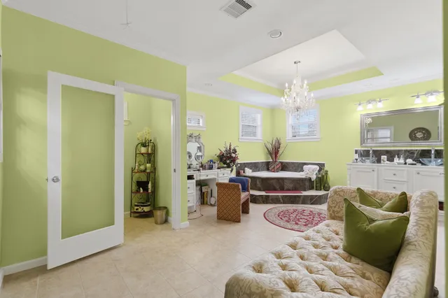 a living room with furniture and a view of bathroom