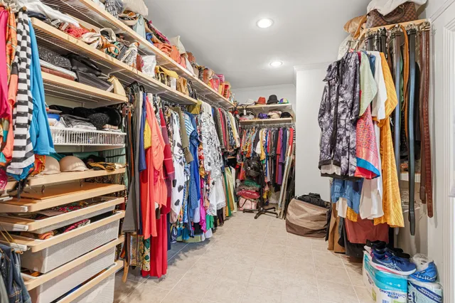 a view of walk in closet with clothes