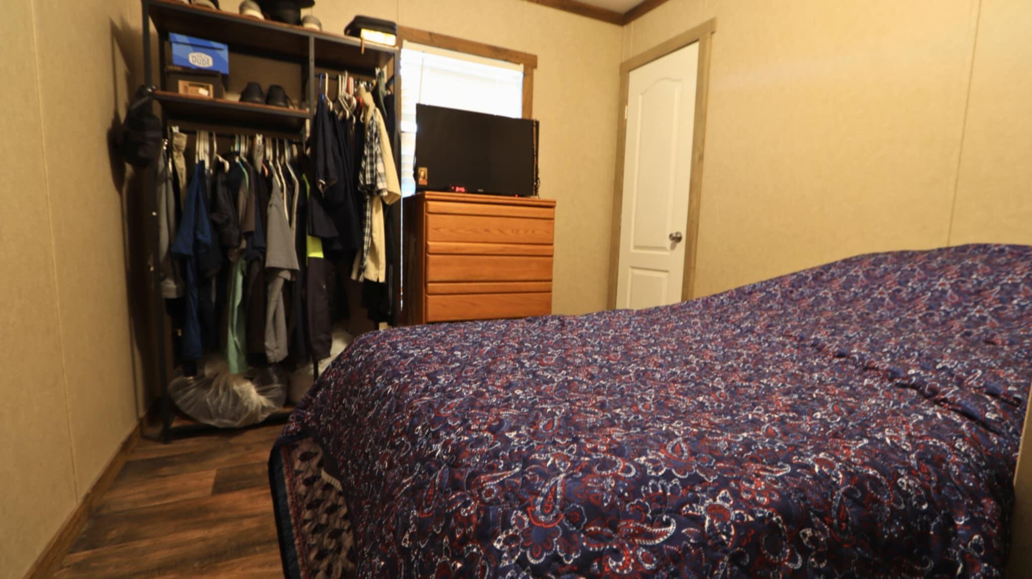 304 3rd Street Wolfforth, TX 79382 - Photo 15 of 16 a bedroom with a bed and a flat screen tv