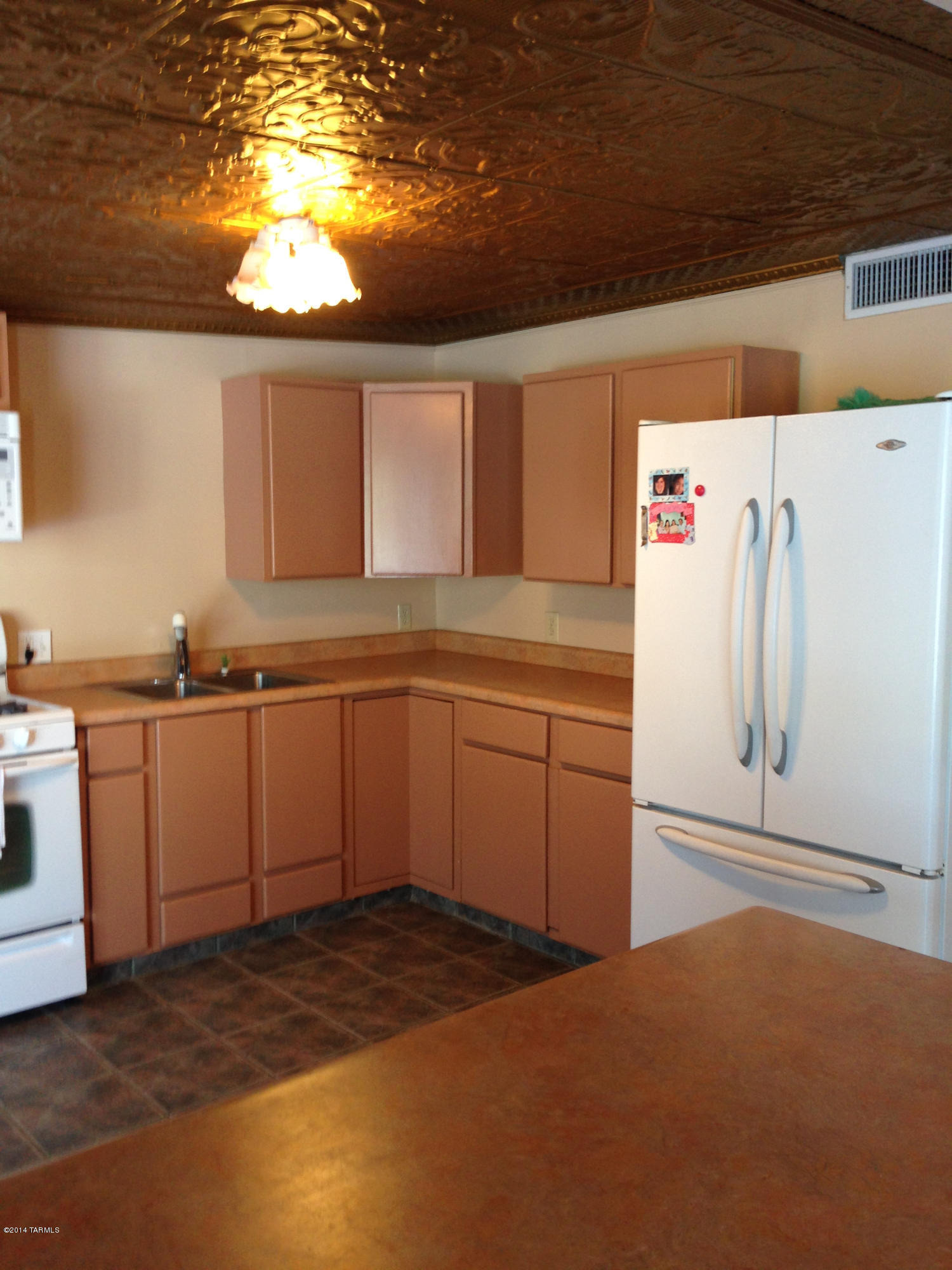 4515 South Aldon Road Tucson, AZ 85735 - Photo 14 of 32 a kitchen with a sink stove and cabinets