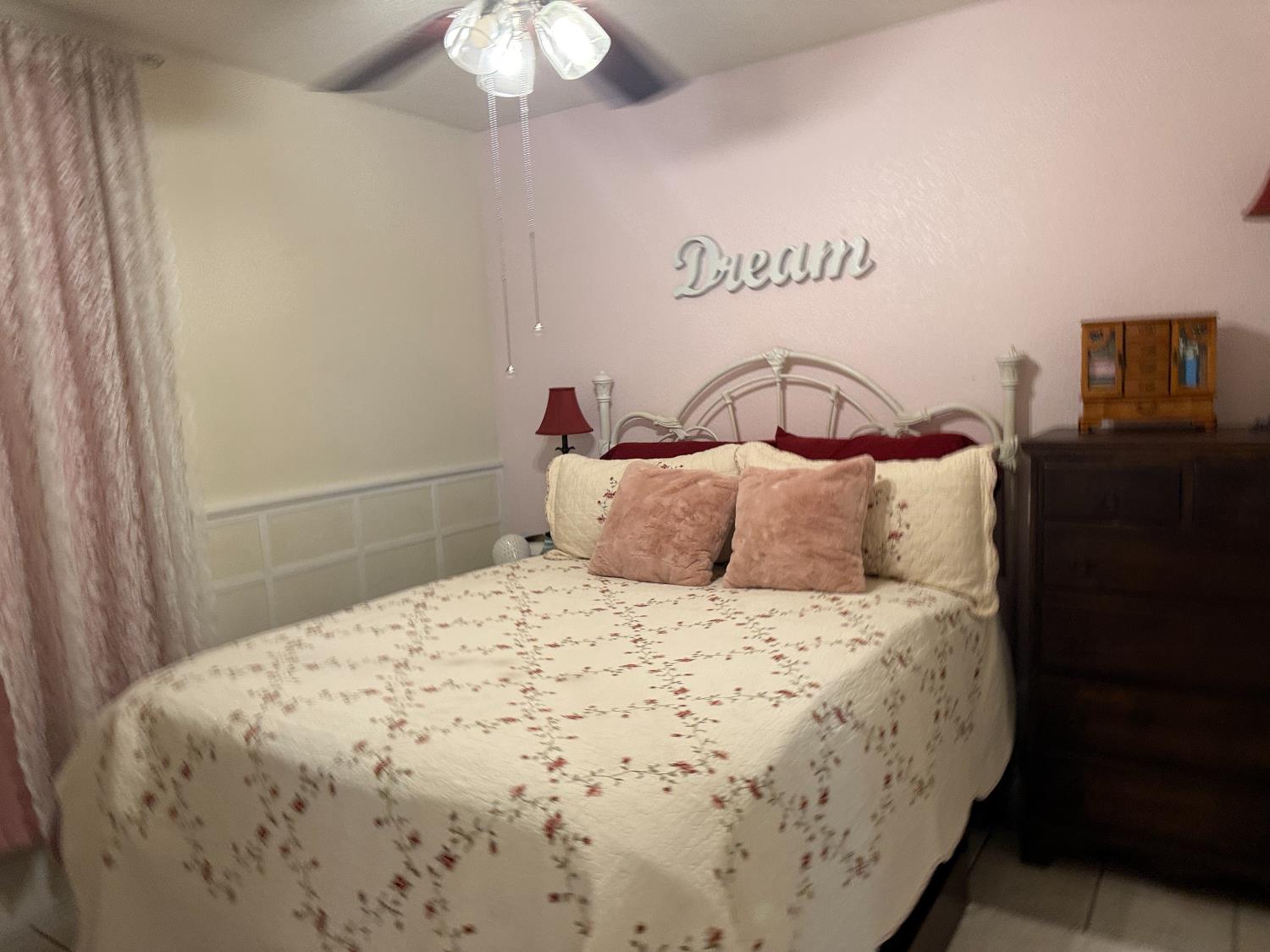 14312 West B Street Kerman, CA 93630 - Photo 11 of 24 a large bed sitting in a bedroom next to a window