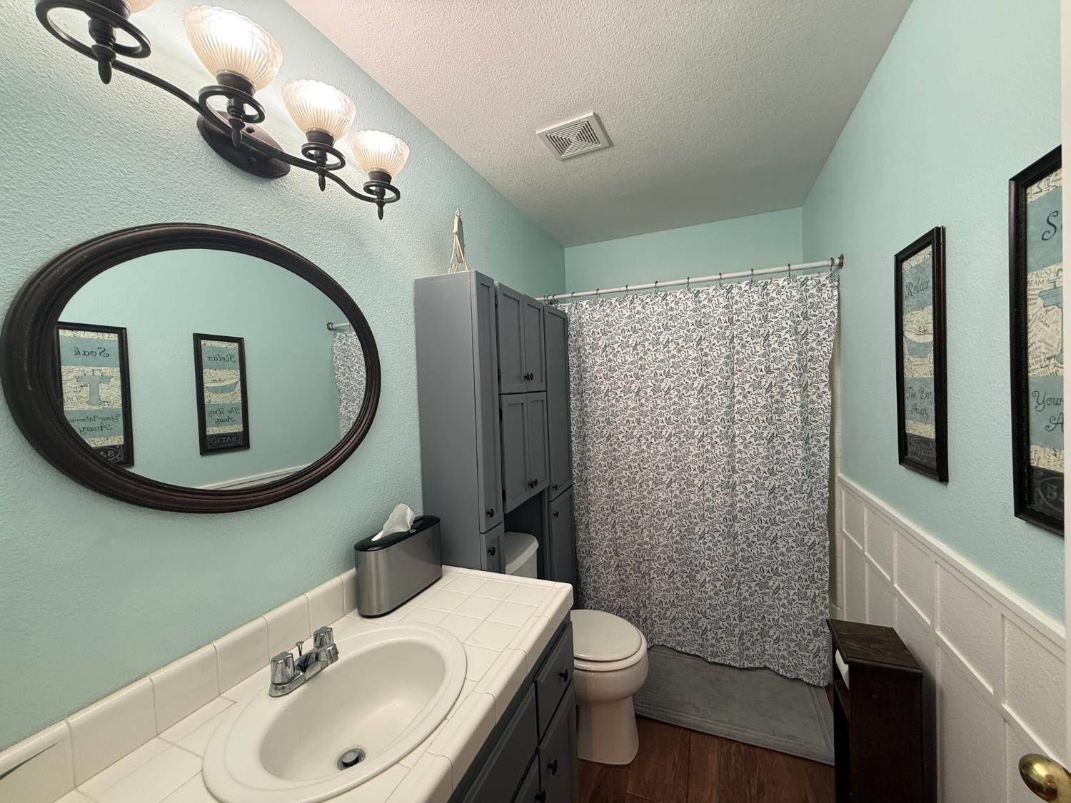 14312 West B Street Kerman, CA 93630 - Photo 12 of 24 a bathroom with a toilet sink and mirror