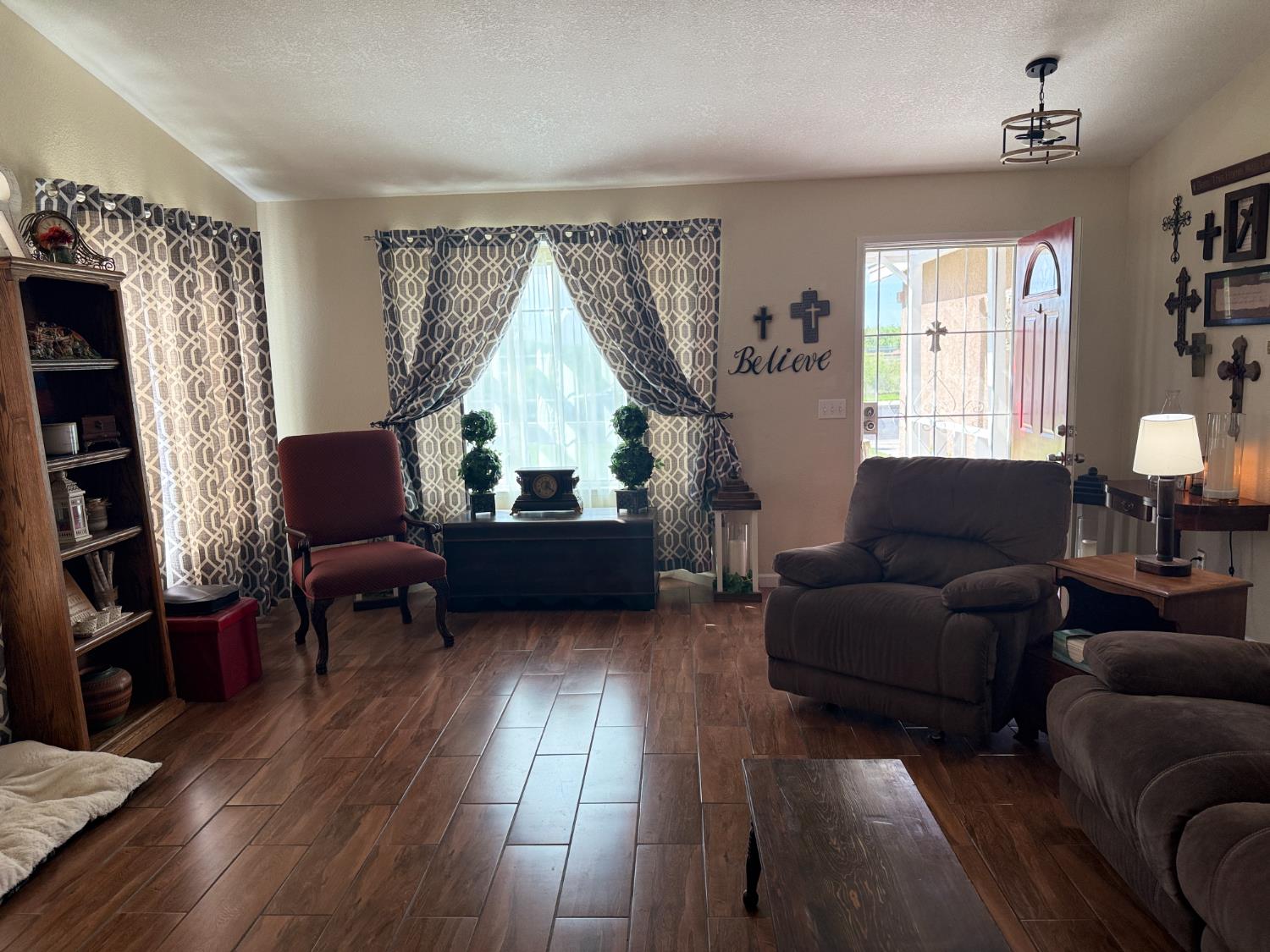 14312 West B Street Kerman, CA 93630 - Photo 3 of 24 a living room with furniture and a wooden floor