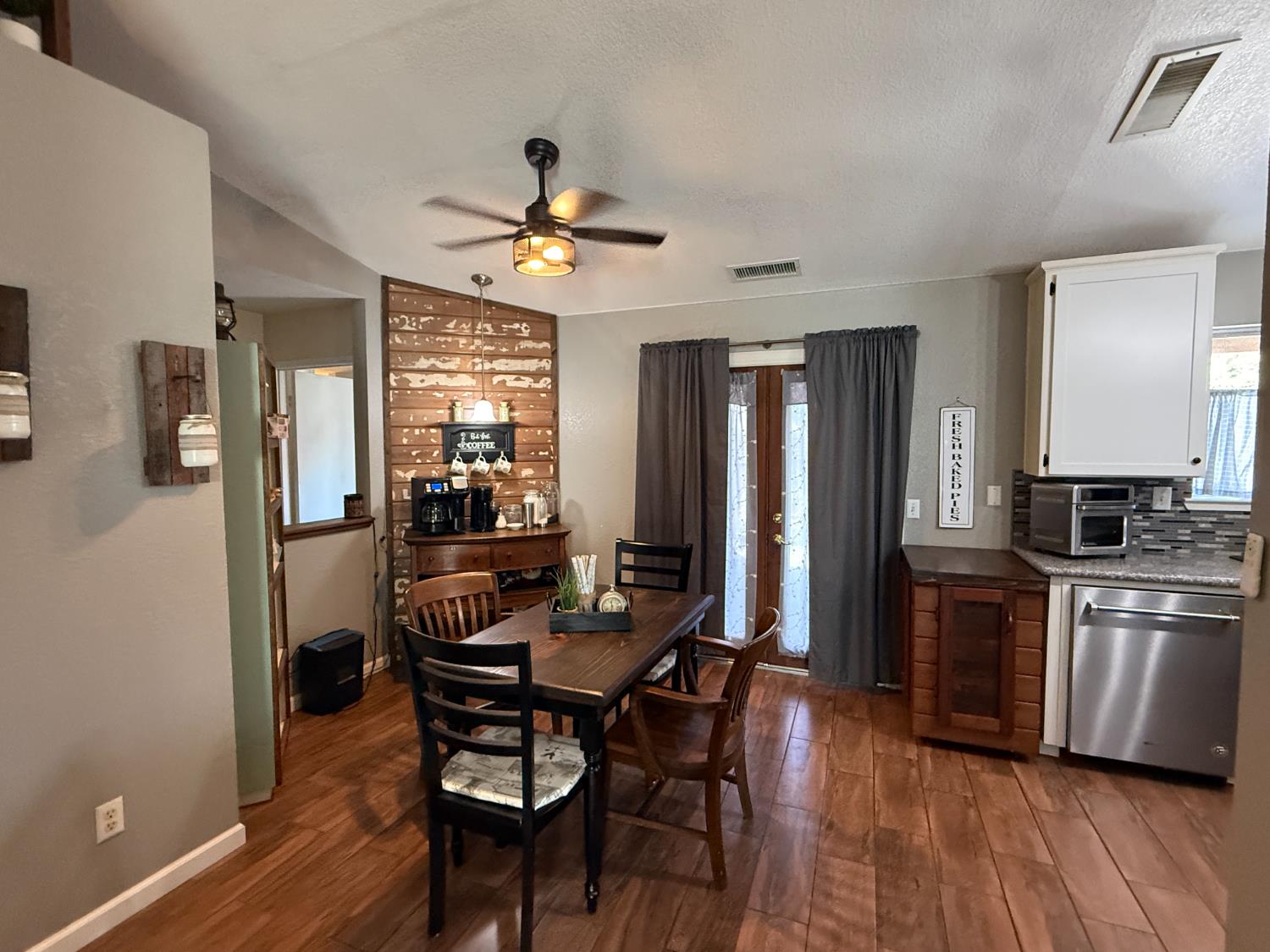 14312 West B Street Kerman, CA 93630 - Photo 6 of 24 a view of a dining room with furniture window and wooden floor
