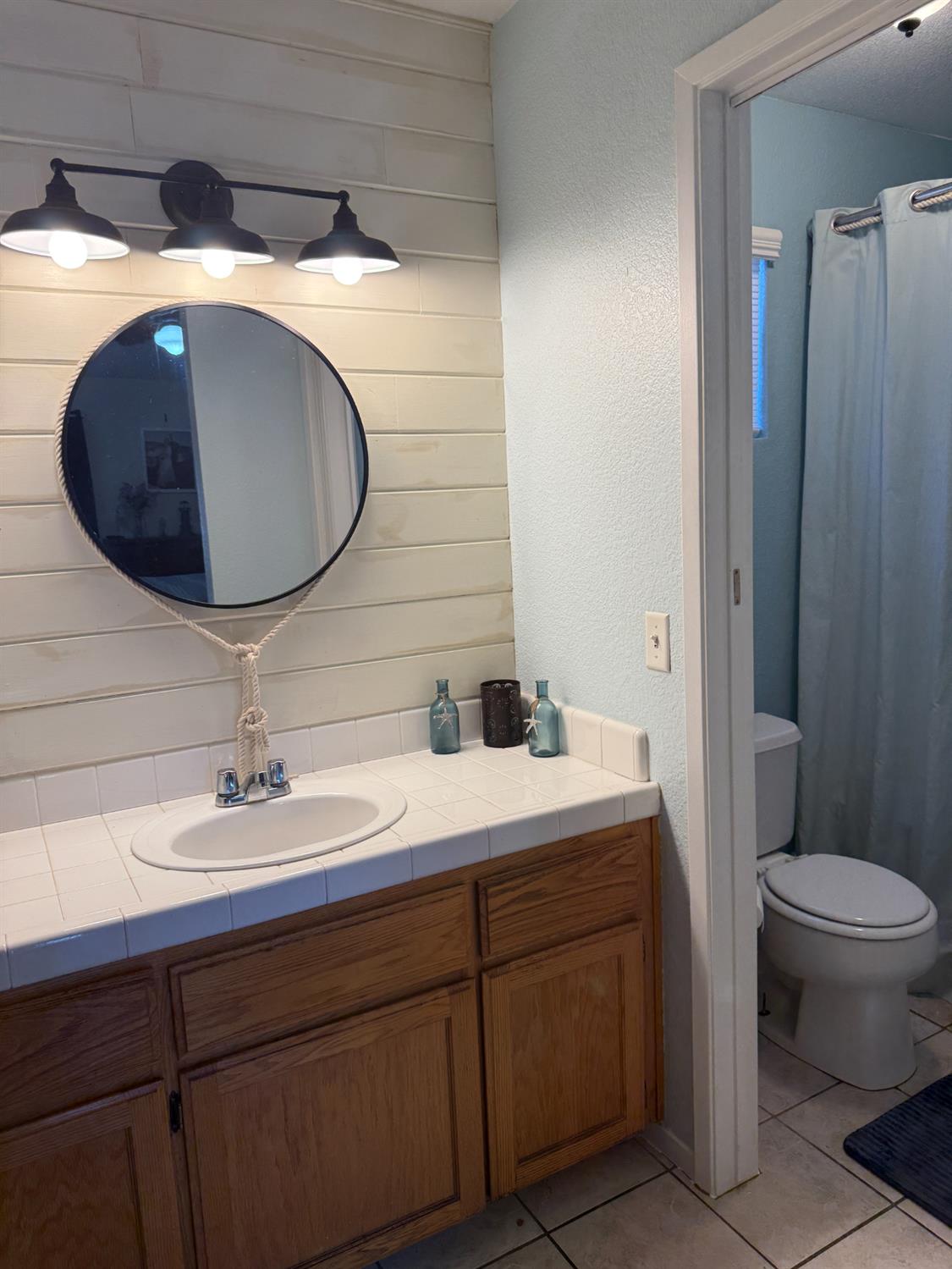 14312 West B Street Kerman, CA 93630 - Photo 9 of 24 a bathroom with a sink and a mirror
